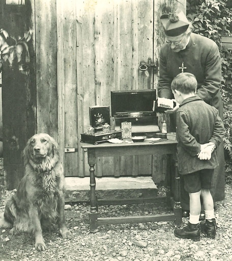 Rev JSM Ward shows young boy artefacts at the Abbey Folk Park