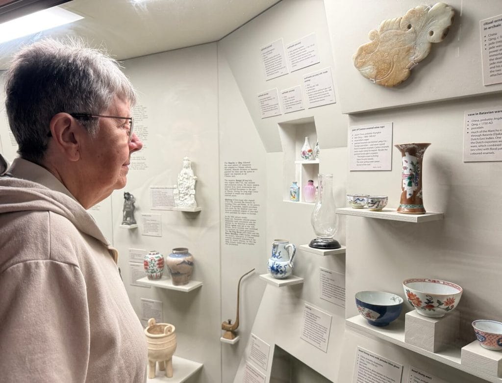 Museum visitor viewing ceramic artefacts inside the Abbey Museum in Caboolture Queensland