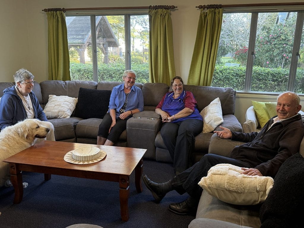 Retreat guests relaxing together in the communal lounge at the Abbey Community Retreat Centre in Caboolture Queensland.